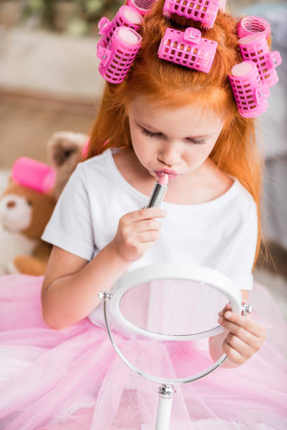 istock girl applying lipstick 843148950