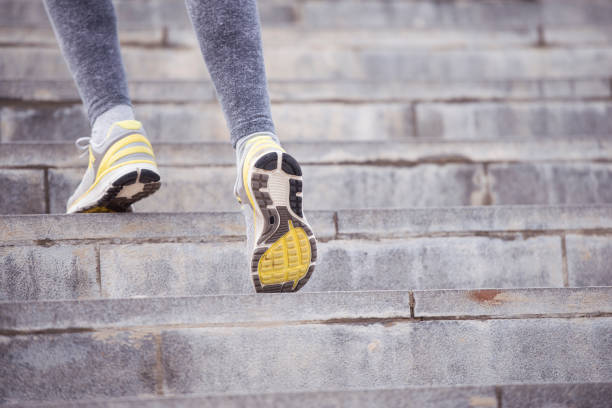 istock Close up active female foot running up stairs. 843154882