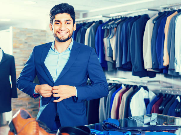 istock Adult guy is trying on jacket 843155300