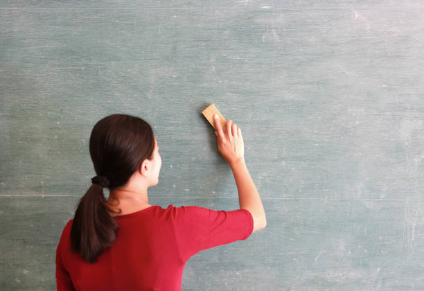 Close-up of a green empty school chalkboard with chalk traces and smudges. Space for copy.