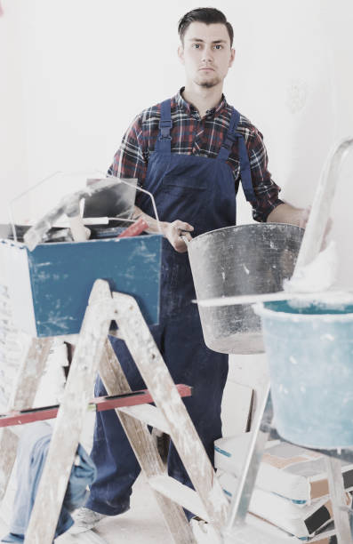 istock Repairman is going to mix putty 843157632