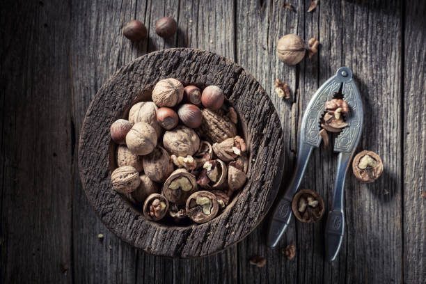 istock Tasty walnuts and hazelnuts with on rustic wooden table 843163994