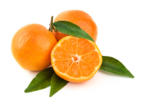 Fresh delicious whole and cut mandarins on branch with green leaves on white background