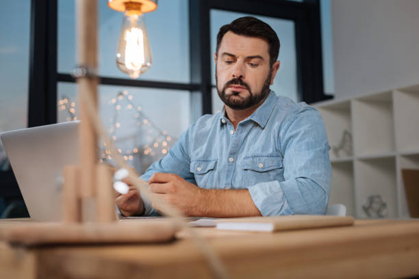 istock Handsome hard working businessman sitting at the table 843169358