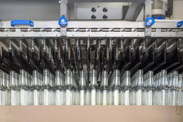 istock A pneumatic manipulator unloads empty glass bottles from a cardboard pallet 843169454