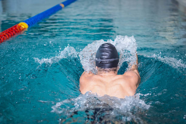 istock Rear view of man swimming 843173956