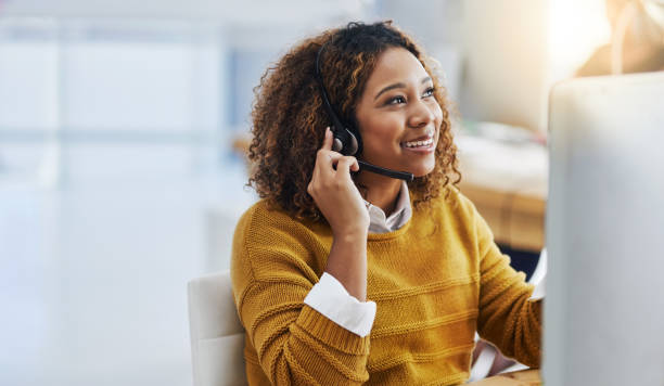 Her display of care in customers is great business Shot of a female agent working in a call centre headset photos stock pictures, royalty-free photos & images