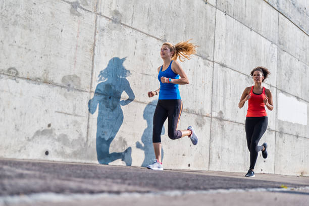 istock Two female athletes running together 843180178