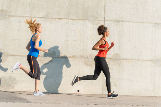 istock Two female athletes running together 843180182