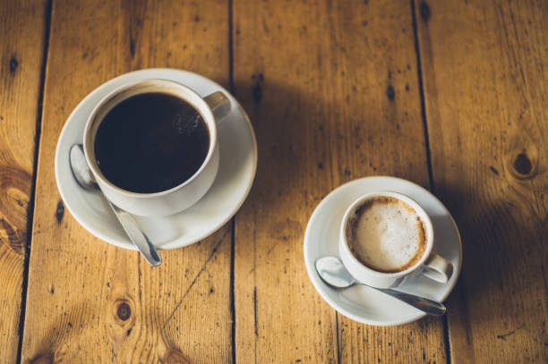 istock Cups of coffee on wooden table 843180578