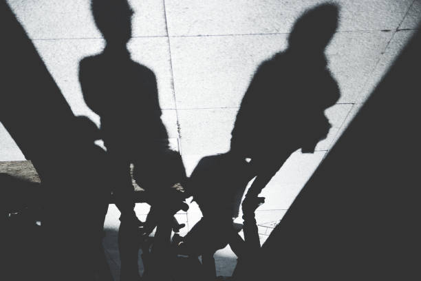 istock Shadow of People on Patterened Sidewalk 843181464