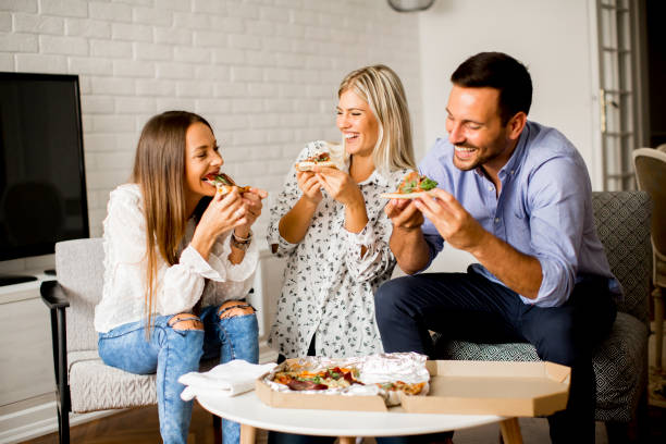 istock Friends eating pizza at home 843182988