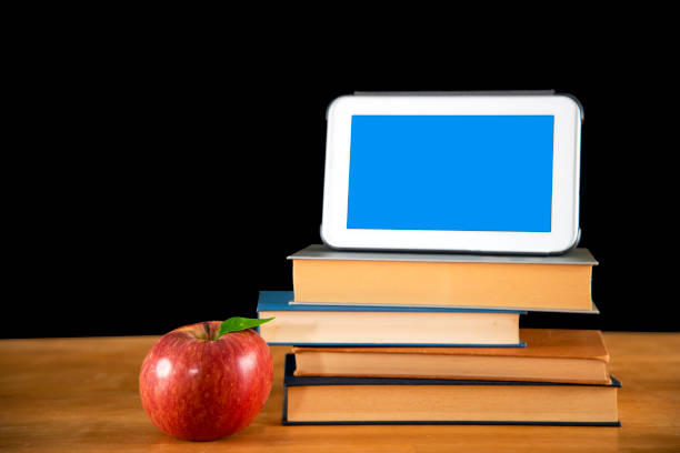istock Vintage books with apple and tablet 843183114