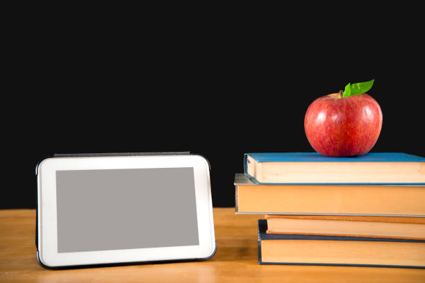 istock Vintage books with apple and tablet 843183280