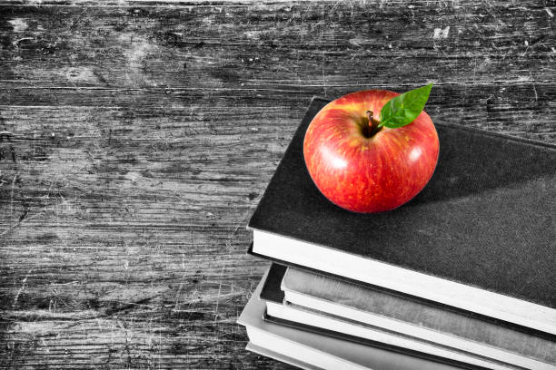 Vintage old books with apple and tablet