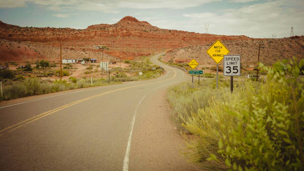 istock Driving a car on winding desert highway 843184114