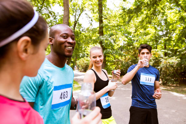 istock Group of young athletes prepared for run, drinking water. 843188444