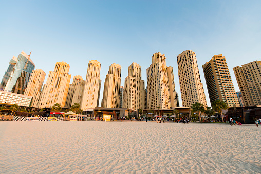 People enjoying a late afternoon at the beach in the Dubai Marina.