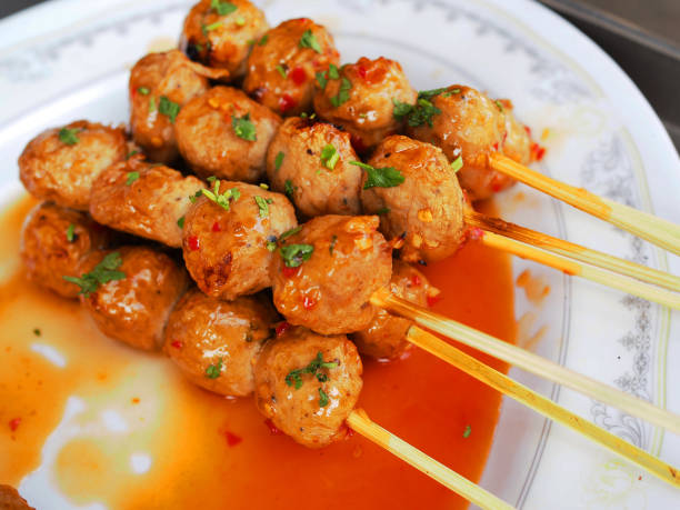 istock Thai local grilled meatball stick with spicy sauce 843194530
