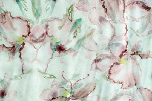 Fabric silk texture, abstract flowers drawn on the fabric