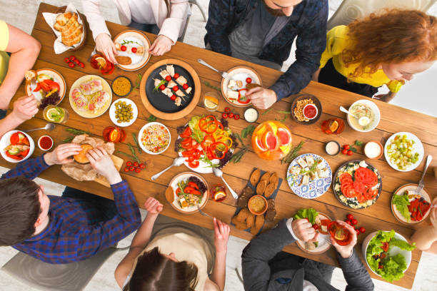 istock People eat healthy meals at served table dinner party 843209686