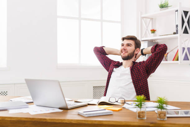 istock Young relaxed businessman with laptop in modern white office 843209998