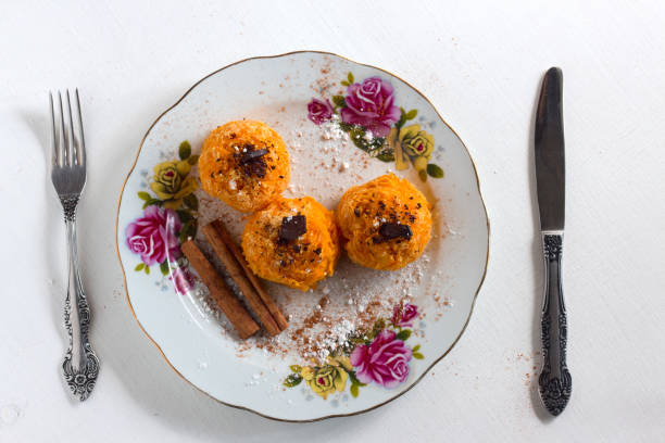 istock Pumpkin dessert with cinnamon, chocolate on plate with knife and fork on white wooden background 843210412