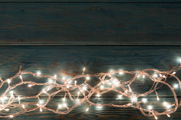 istock Christmas rustic background - vintage planked wood with lights and free text space 843210592