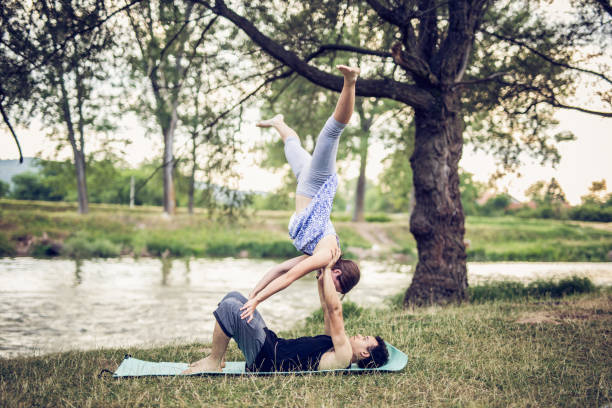istock Couple practicing acro yoga in nature 843213746