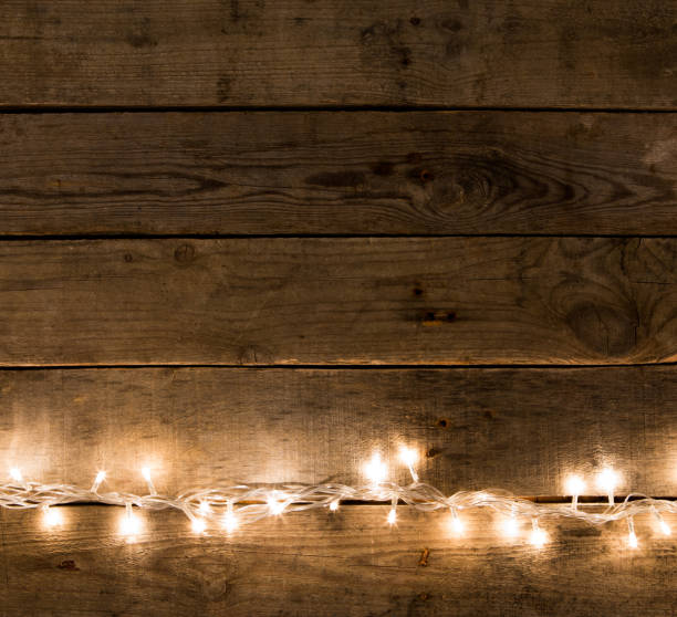 istock Christmas rustic background - vintage planked wood with lights and free text space 843214606