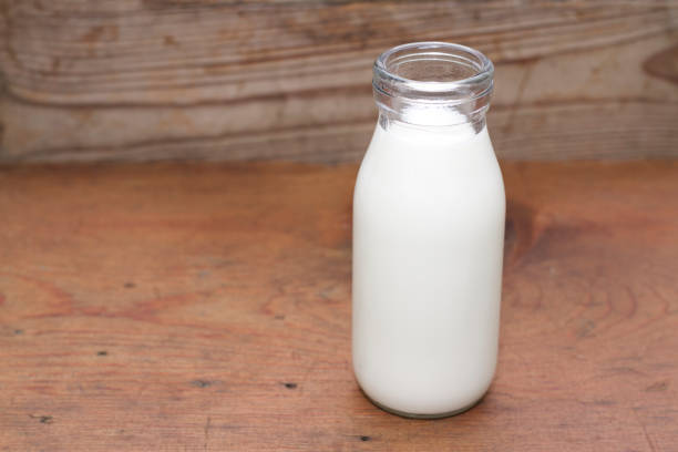 istock Milk and old style bottle on wood table 843215042