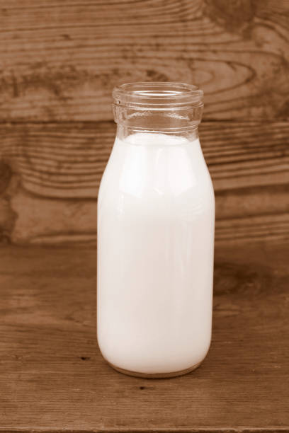 istock Milk and old style bottle on wood table 843215080