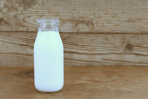 istock Milk and old style bottle on wood table 843215082