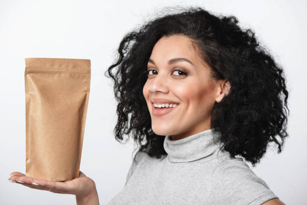 istock Smiling woman showing craft paper pouch bag 843219016