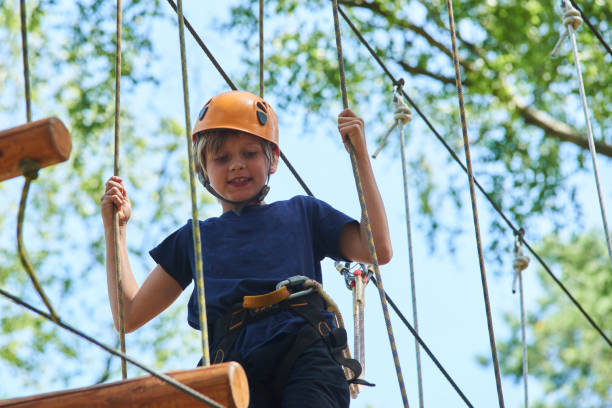 istock Child boy enjoys climbing in the ropes course adventure. 843222556