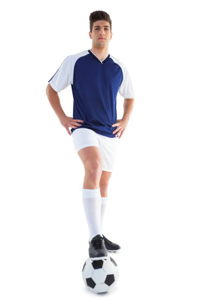 istock Football player in blue standing with the ball 843226334