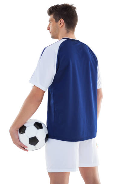 istock Football player in blue standing with the ball 843226518