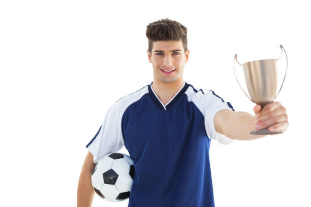 istock Football player in blue jersey holding winners cup 843229676