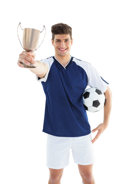 istock Football player in blue jersey holding winners cup 843229732