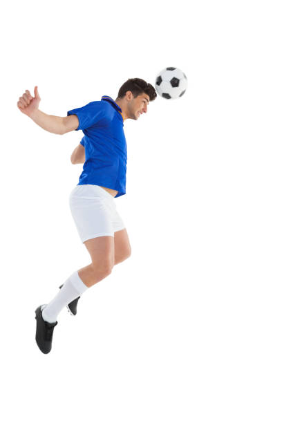 istock Football player in blue jersey heading ball 843230488