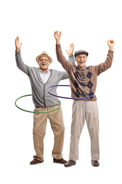dos ancianos alegres con aros de hula - hooping fotografías e imágenes de stock