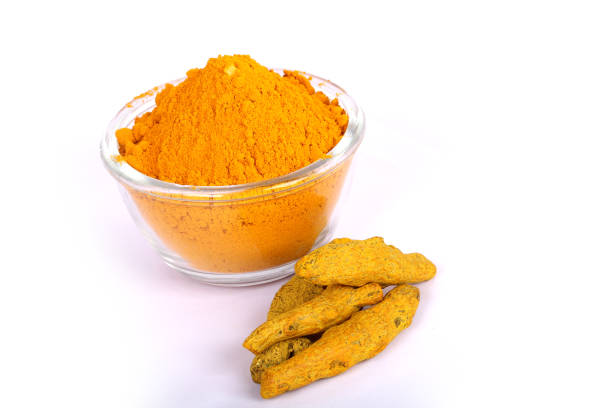 istock turmeric powder with fresh turmeric root in white 843234192