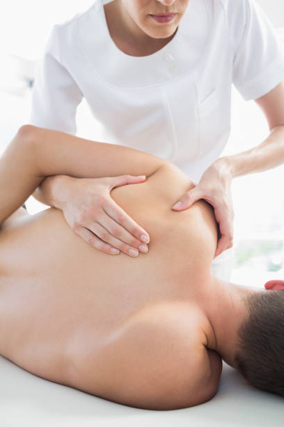 istock Professional therapist giving shoulder massage to man 843239230