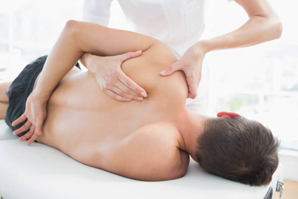 istock Physiotherapist giving shoulder massage to man 843240678