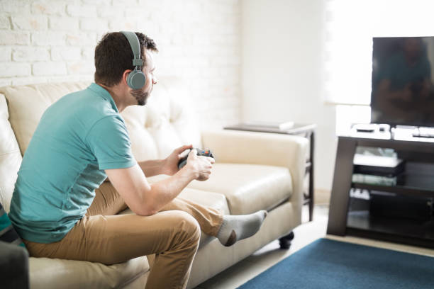 istock Man having fun indoors with a video game 843242758