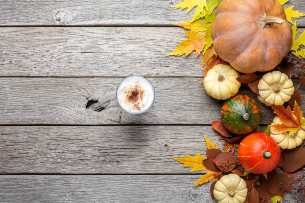 istock Autumn background with yellow leaves and pumpkins 843245396