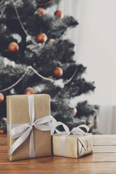 istock Christmas presents on decorated tree background, holiday concept 843246408