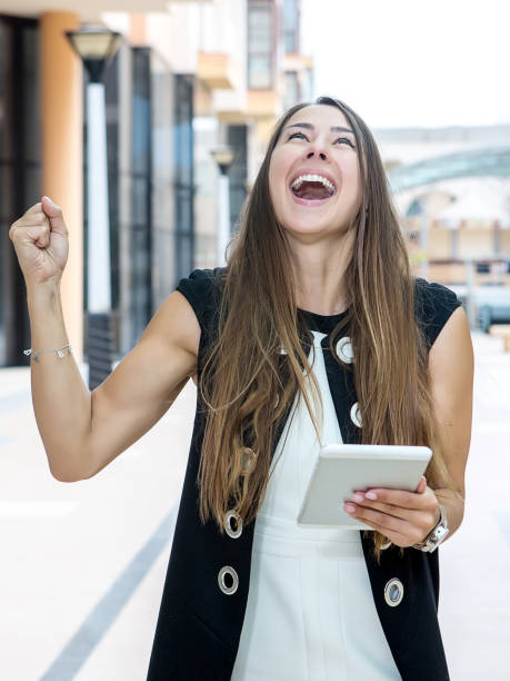 istock Victorious businesswoman with table 843248458