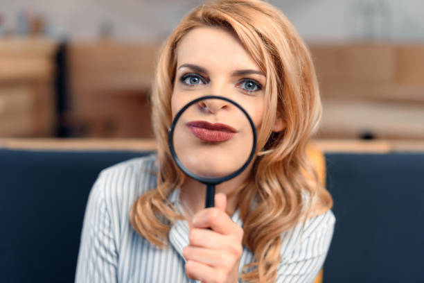 istock businesswoman holding magnifier 843249836