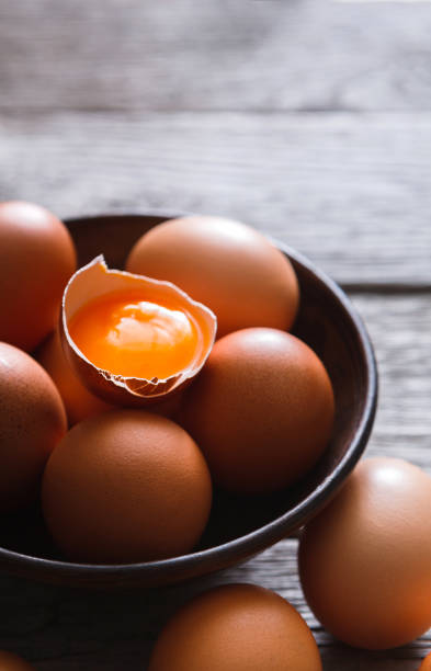 istock Fresh brown eggs in bowl on wood background 843249926